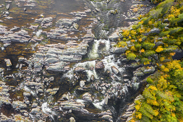 Limestone Formations Amidst Sweden's Fall Splendor. Rugged limestone structures juxtaposed with vibrant fall foliage, exemplifying Sweden's diverse landscape
