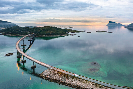 Aerial view of car traveling on Sommaroy bridge at sunset, Sommaroy, Troms county, Northern Norway, Scandinavia