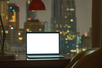 laptop computer on table white display see through city on night - 469527336