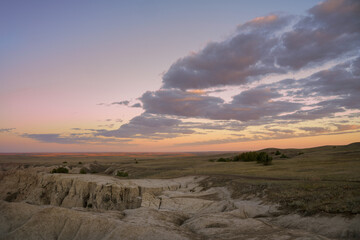 Fototapeta premium Sunrise over where the badlands meet the high plains of South Dakota at Badlands National Park