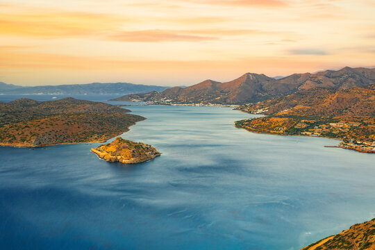 Spinalonga island in the blue sea of Mirabello gulf at sunrise, Plaka, Lasithi prefecture, Crete, Greek Islands