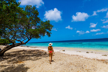 Woman enjoying the white sandy beaches and clear blue waters of Bonaire, Netherlands Antilles, Caribbean, Central America