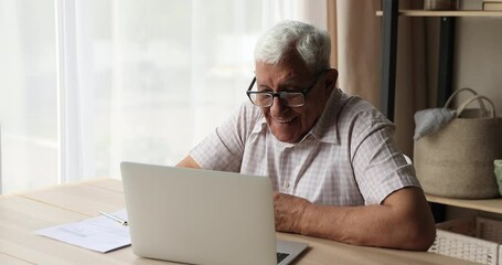 Smiling aged male virtual banking service client enjoy easy convenient work from home at online app on pc. Happy elderly grandpa satisfied with user friendly interface of information search at website