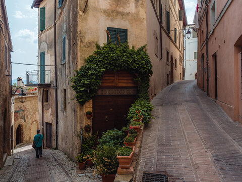 A person walking in the central streets of Trevi's old town at a fork, Trevi, Umbria, Italy