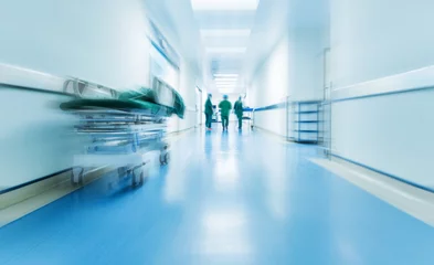 Fotobehang Doctors or nurses walking in hospital hallway, blurred motion © xy