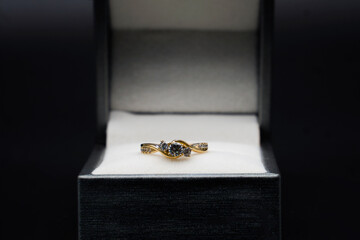 Diamond ring in jewelry gift box on black background	