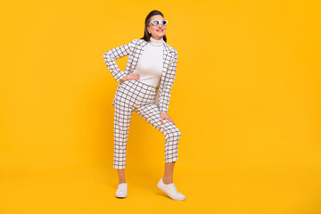 Full body photo of satisfied glad person hand on waist posing isolated on bright yellow color background