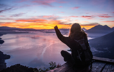 Tourist enjoying the sunrise from La Rostra Maya, Lake Atitlan, Guatemala