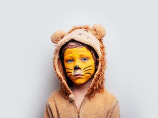 Upset boy in lion costume