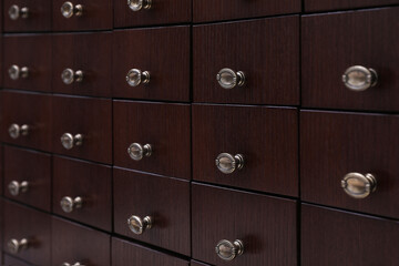 Library catalog. Wooden chest of drawers, closeup