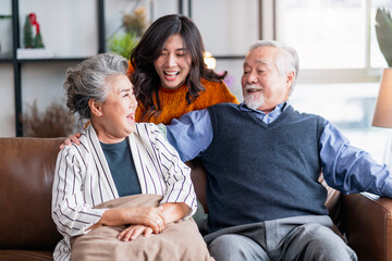happiness asian family candid of daughter hug grandparent mother farther senior elder cozy relax on sofa couch surprise visiting in living room at home,together hug cheerful asian family at home - Powered by Adobe