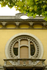 Circular window. Circular window of a secessionist house.Quaroni house in Novara inspired by the principles of the Viennese secession.  - obrazy, fototapety, plakaty