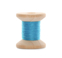 Wooden spool of light blue sewing thread isolated on white