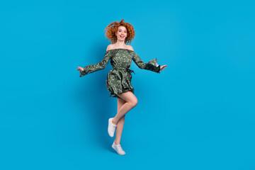 Fototapeta na wymiar Full body photo of sporty ginger hairdo lady jump wear dress isolated on blue color background