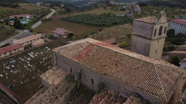 Drone view towards the clock tower and above the cemetery and the small village of Monroyo in Matarra&ntilde;a region in Spain_5