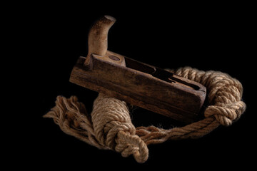 Old wooden planes on a rope. Isolated on a black background.