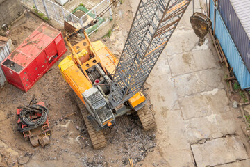 Construction crane boom on crawler tracks, aerial view.