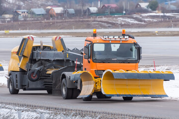 Snowplow rides at the airport, view of the cabin near.