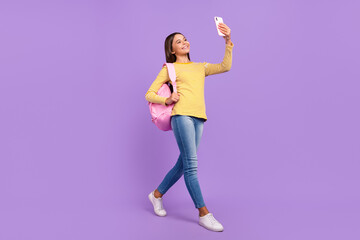 Full length profile side photo of youth lady speak video cellphone shoot picture bag vlogging isolated over purple color background