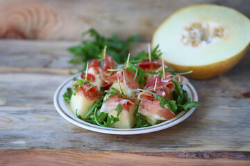 Melon, jamon, arugula appetizer.