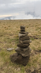 Fototapeta na wymiar Pyramid of stones on the top of the mountain