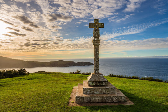 Landmark by sea. Ancient stone cross a traditional religious symbol known as cruzeiro in Cedeira, Galicia Spain