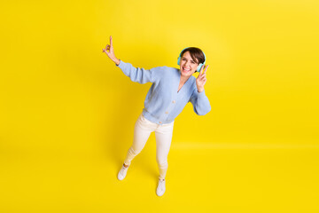 Full length body size above high angle view of lovely cheerful girl listening hit dancing isolated...