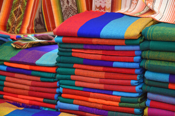 stack of colorful fabrics in market in Peru