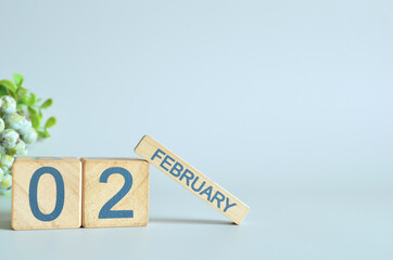 February 2, Calendar cover design with number cube with green fruit on blue background.