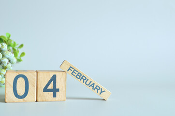 February 4, Calendar cover design with number cube with green fruit on blue background.