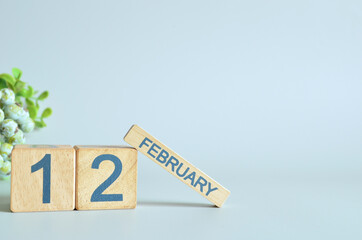 February 12, Calendar cover design with number cube with green fruit on blue background.