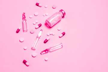 Vaccine and syringe, assorted pharmaceutical medicine pills, tablets and capsules background. Healthcare and medical concept.