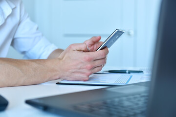 Office manager writes message on smartphone.