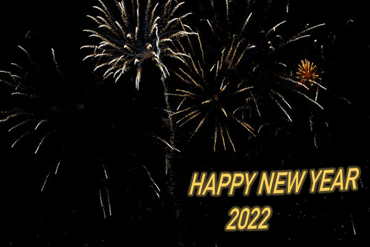 Fireworks to congratulate the new year 2022 with yellow or gold letters - Powered by Adobe