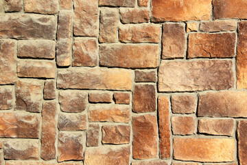 Texture of a wall made of decorative artificial stones of different sizes