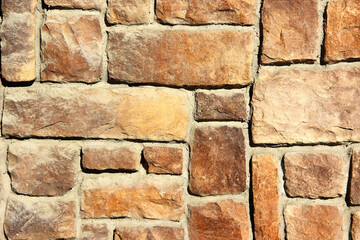 Texture of a wall made of decorative artificial stones of different sizes