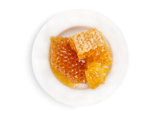 Pieces of honey in combs on a white plate. View from above. Isolate on a white background.