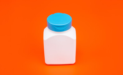 drug jar white color on orange background, vitamin