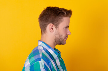 Fototapeta premium Handsome and unshaven. Young man in profile. Profile portrait of caucasian guy