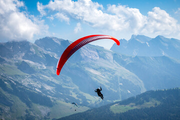 paragliding flight in the mountains. Le Grand-Bornand, France - obrazy, fototapety, plakaty