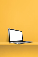 Laptop computer on yellow shelf. Vertical background