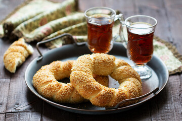 Traditional Turkish simits served with tea. Rustic style.