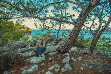 rasta girl with dreadlocks resting on the Mediterranean coast