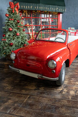 Large number of gifts are loaded into the open trunk of a red retro car
