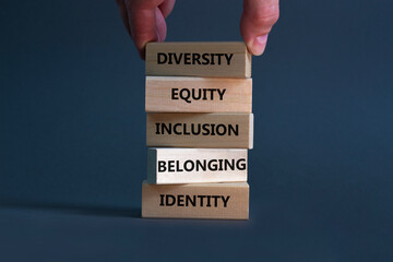 Diversity, equity, inclusion, belonging, identity symbol. Wooden blocks with words Diversity, equity, inclusion, belonging, identity on beautiful grey background. Business, Inclusion concept.