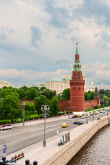 Fototapeta premium view from the bridge to the towers of the Moscow Kremlin and the Moskva River embankment against the background of a cloudy sky. Moscow. Russia