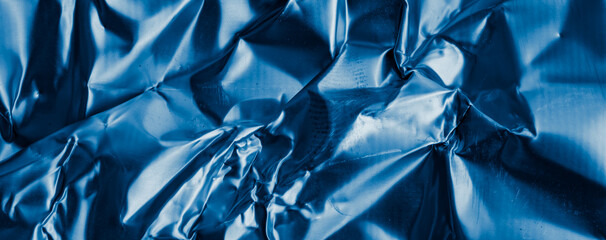 crinkled blue foil with visible details. background or texture