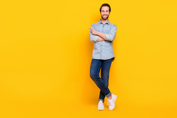 Fototapeta na wymiar Full body photo of young cheerful man happy positive smile point finger empty space ad advice isolated over yellow color background