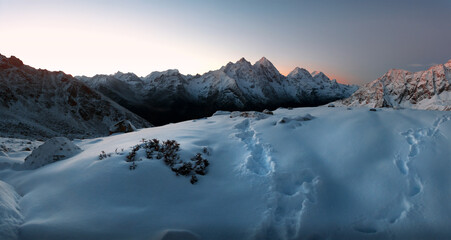 mountain peaks and ridges covered with snow at sunrise in Karachay-Cherkessia