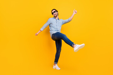 Fototapeta na wymiar Full length photo of young excited man happy positive smile have fun enjoy party dance isolated over yellow color background